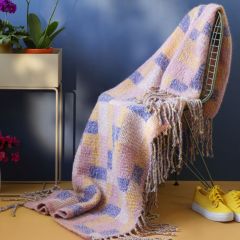 Free pattern: Molla Mills Blanki Blanket. Big colourful crochet blanket on a chair. Used Esito worsted wool shades in the blanket: undyed, light pink, blue, light yellow and baby pink Esito looped mohair yarn.